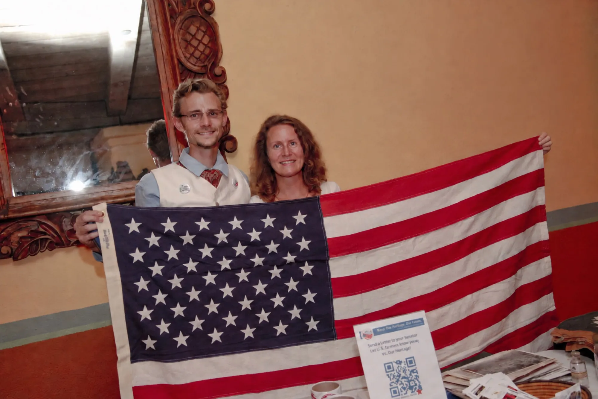 Tyler Hemp and Dodee holding an American flag made from hemp