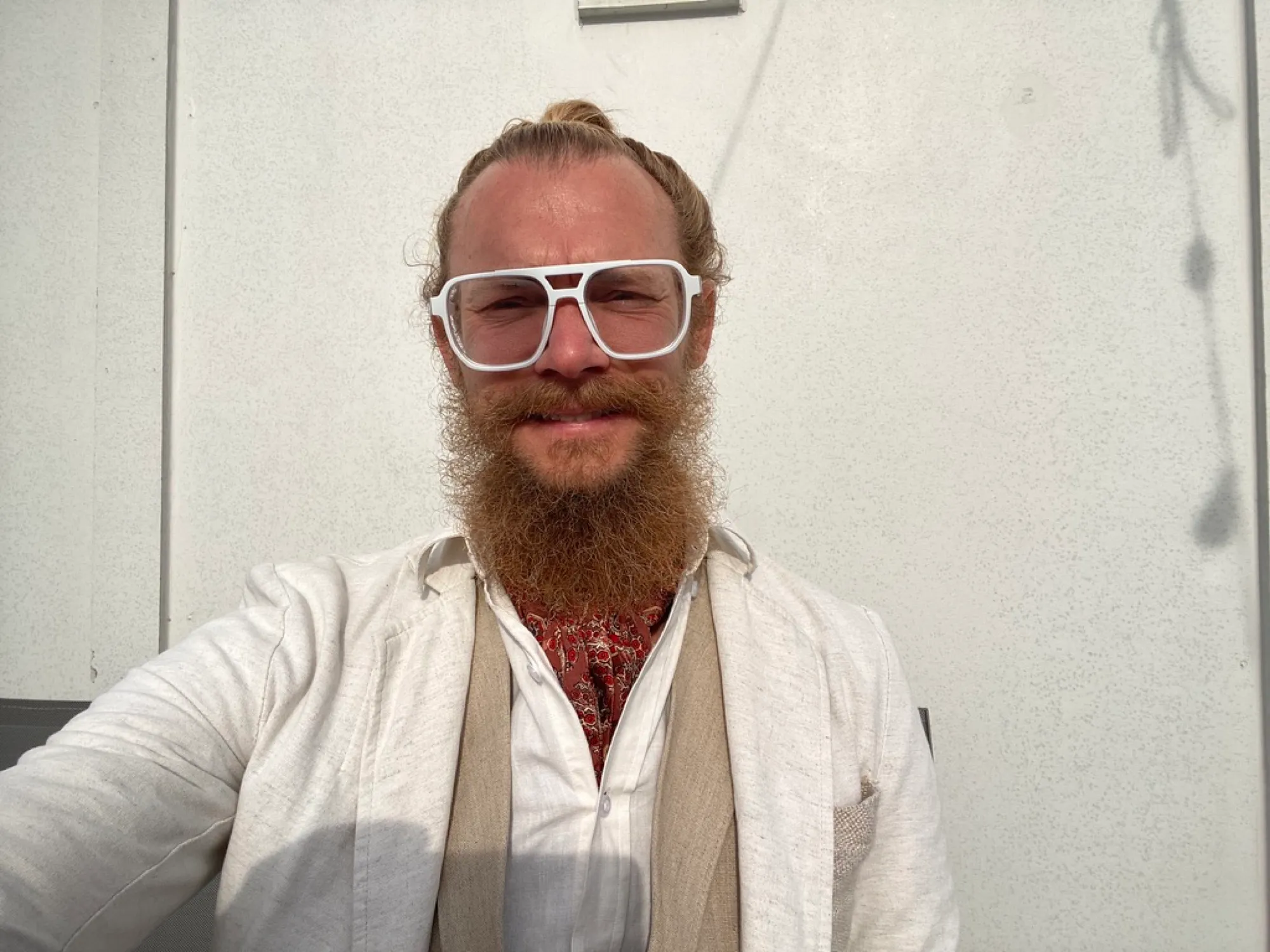 Tyler Hemp, founder of HempAware, with a long beard and white-framed glasses